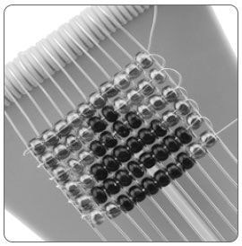Six rows of beads on a loom